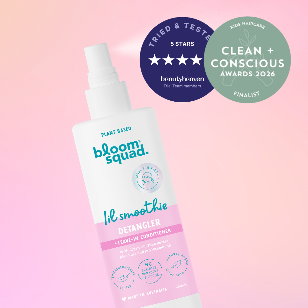 Detangler Spray with awards on a pink background